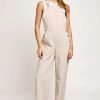 Beige sleeveless wide leg jumpsuit with side buttons, ideal for a boho flowy look