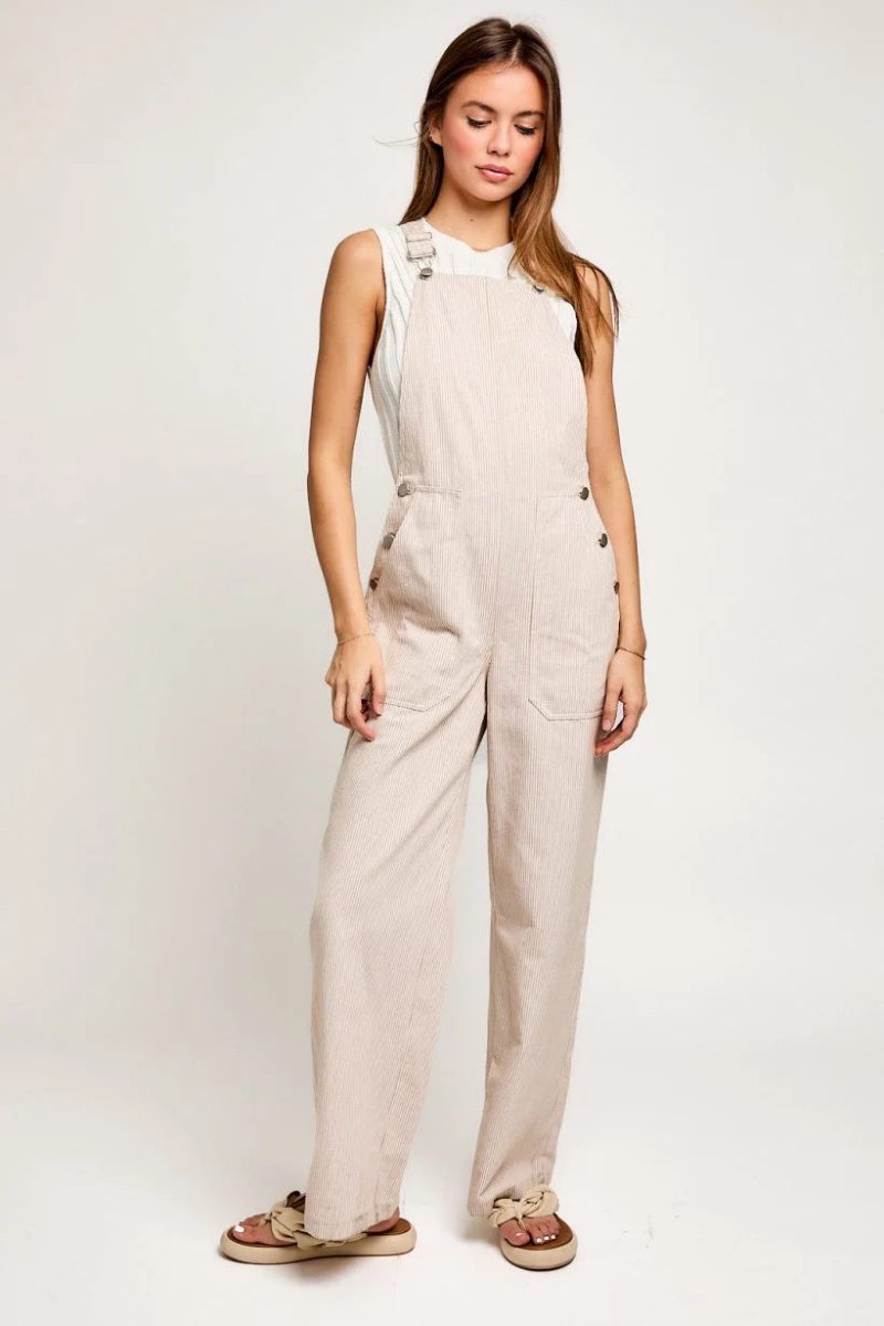 Beige sleeveless wide leg jumpsuit with side buttons, ideal for a boho flowy look