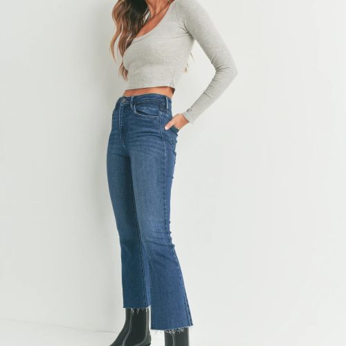 Cropped flare denim jeans styled with a grey long-sleeve top and black leather boots