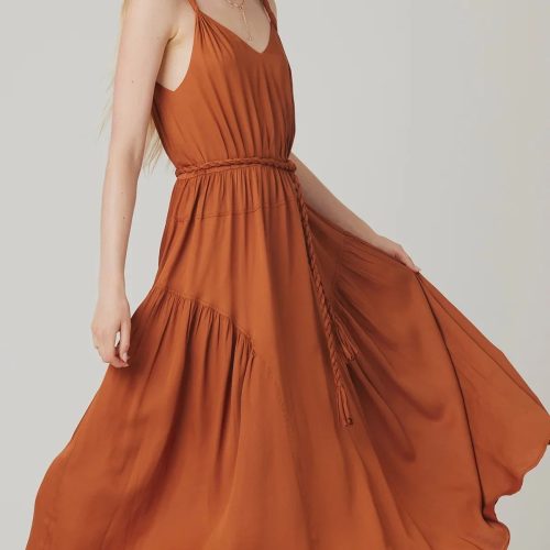 Rust-colored AURA MIDI DRESS featuring a flowy tiered skirt and cinched waist