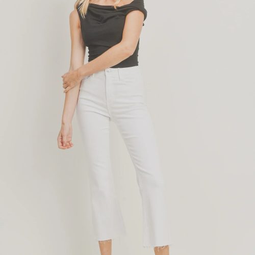 White cropped flare denim styled with a black off-shoulder top and loafers