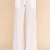 White textured woven adjustable tie waist pants with a drawstring for stylish comfort