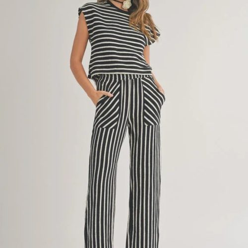 Woman in a black and white striped jumpsuit showcasing a textured stripe knitted design