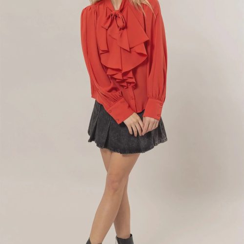 Woman in a red ruffled blouse and mini skirt showcasing women’s boho chic clothing