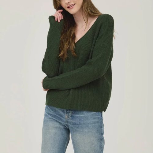 Woman in dark green V Neck Long Sleeve Ribbed Sweater paired with blue jeans