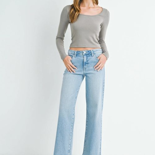 Woman in gray crop top and light blue jeans showcasing MID RISE SLIM WIDE LEG style