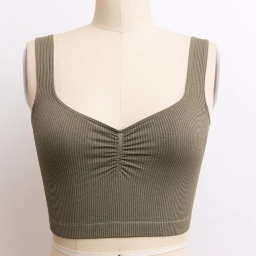 Woman modeling a Basic Ribbed Cinched Crop Top in vibrant green color