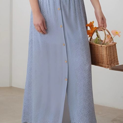 Woman wearing a white top and blue patterned button floral maxi skirt with elastic waist