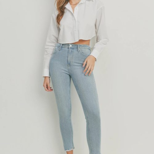 Woman in a white shirt and jeans showcasing THE HR Essential Skinny Denim