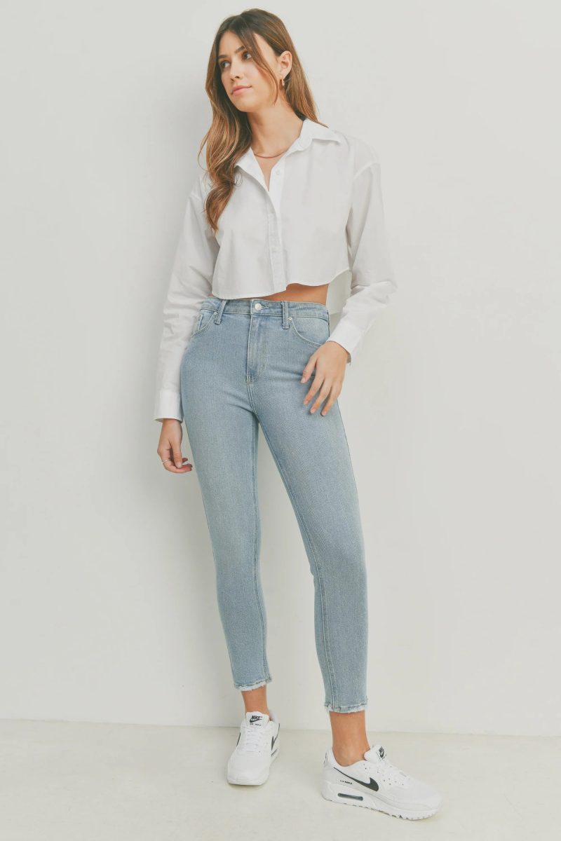 Woman in a white shirt and jeans showcasing THE HR Essential Skinny Denim