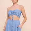 Young woman modeling Bamboo Textured Woven Cinch Bandeau Top with matching skirt